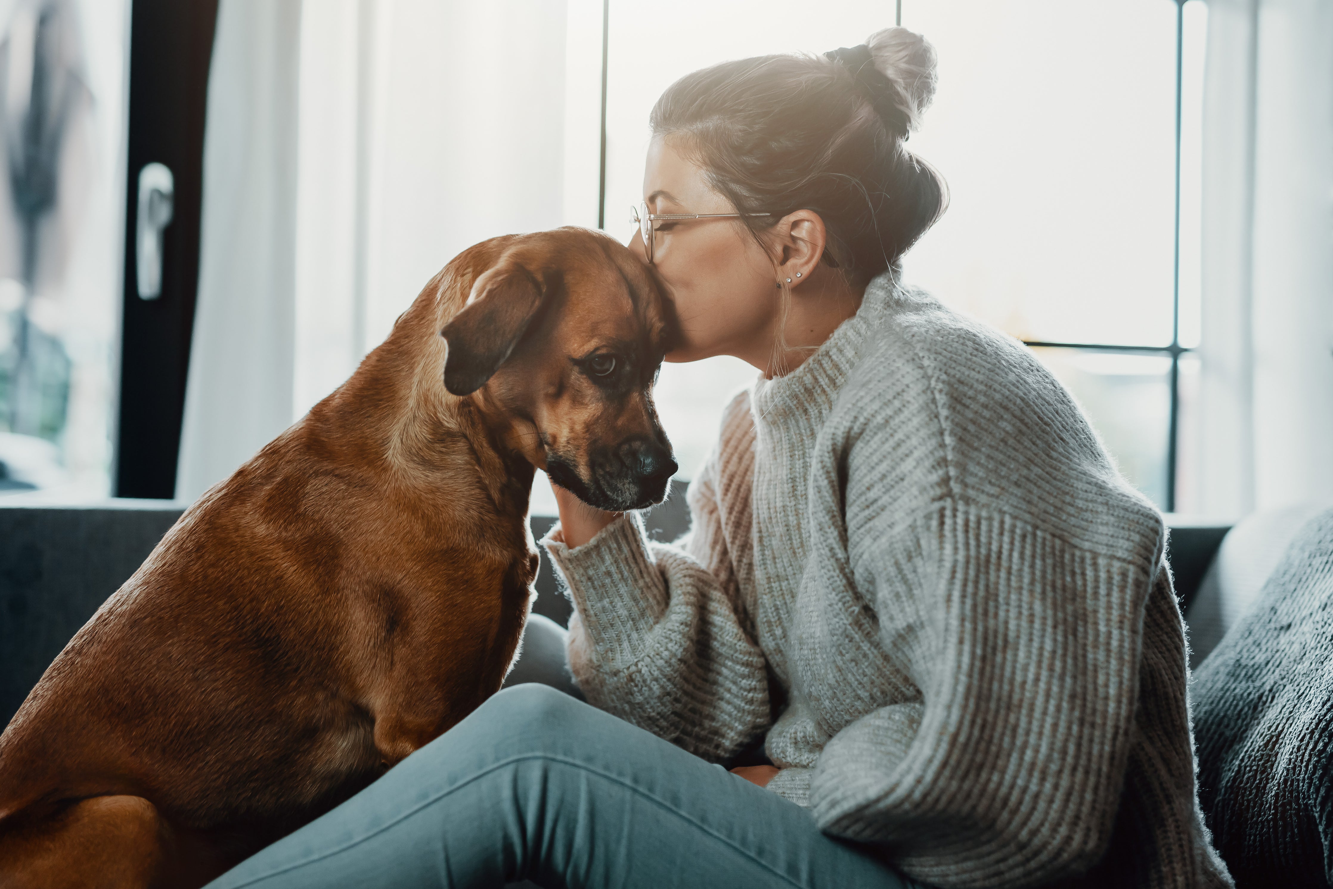 Women kissing dog